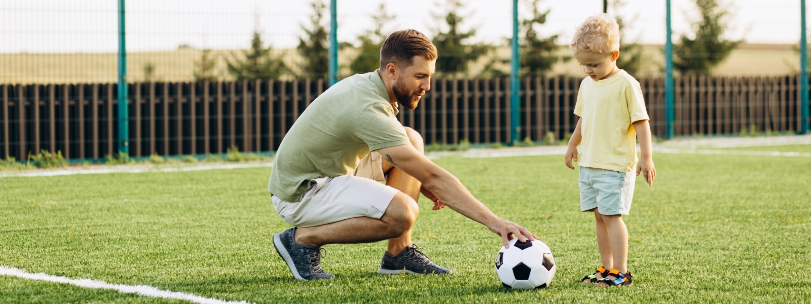 parent and child playing soccer